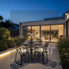 Evening view of a modern house with an outdoor dining area.