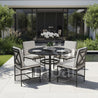 Outdoor patio set with round table and chairs on a patio area.
