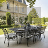 Outdoor dining set with table and chairs in a garden setting.