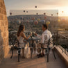 Milan Bistro Set – Buz Hazneli Masa Takımı. Couple enjoying a romantic moment with hot air balloons in the background.
