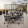 Pier 18 10 kişilik outtdoor masa, Spring Cast aluminyum sandalye,Outdoor dining set with table and chairs on a patio, featuring the brand 'Ambar'.